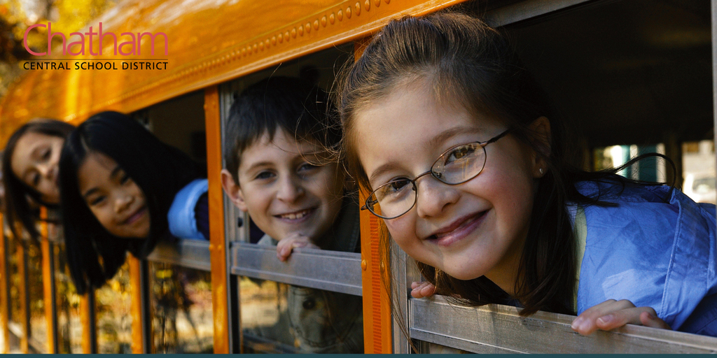 students looking out of school bus windows