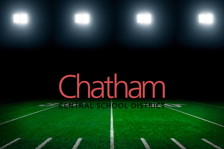 football field lights shining on grass and Chatham CSD logo