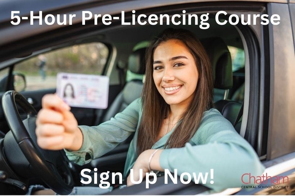 young woman sitting in car holding driver's license