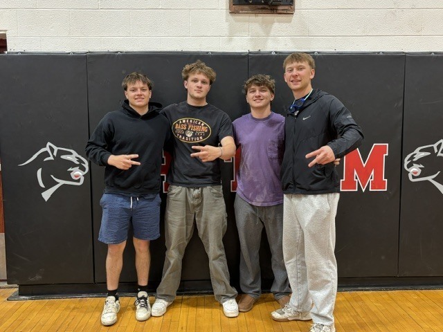 four boys posing for photo making two sign with their hands