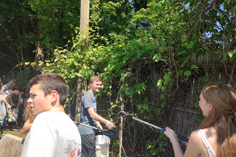 students cleaning up fenceline
