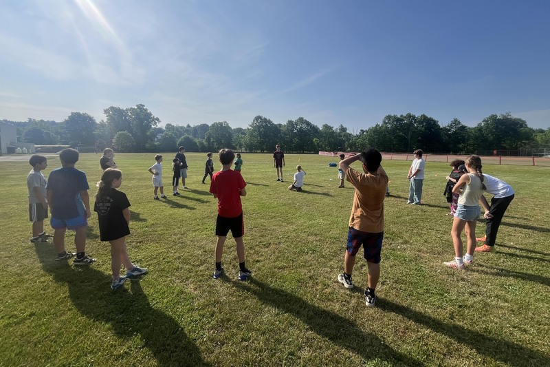 large group of students playing lawn game
