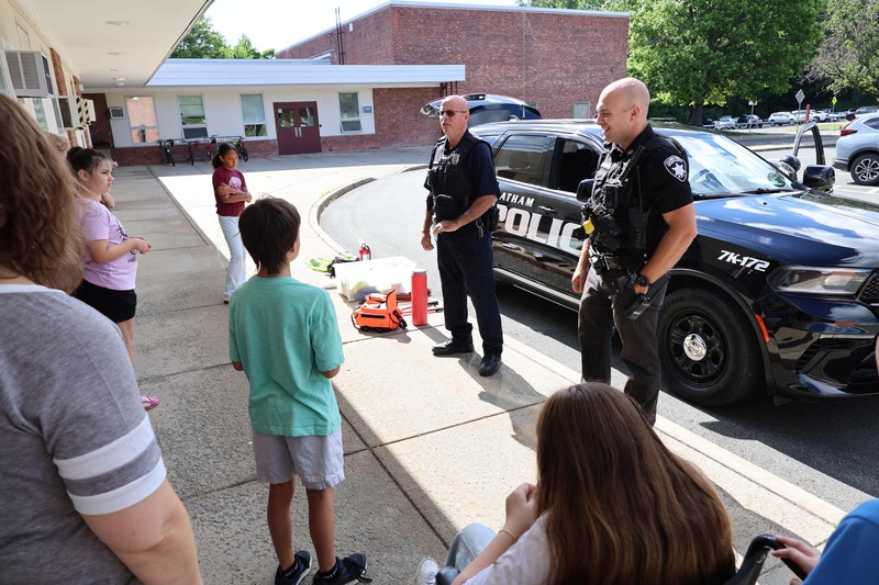 two policemen talking with group of students