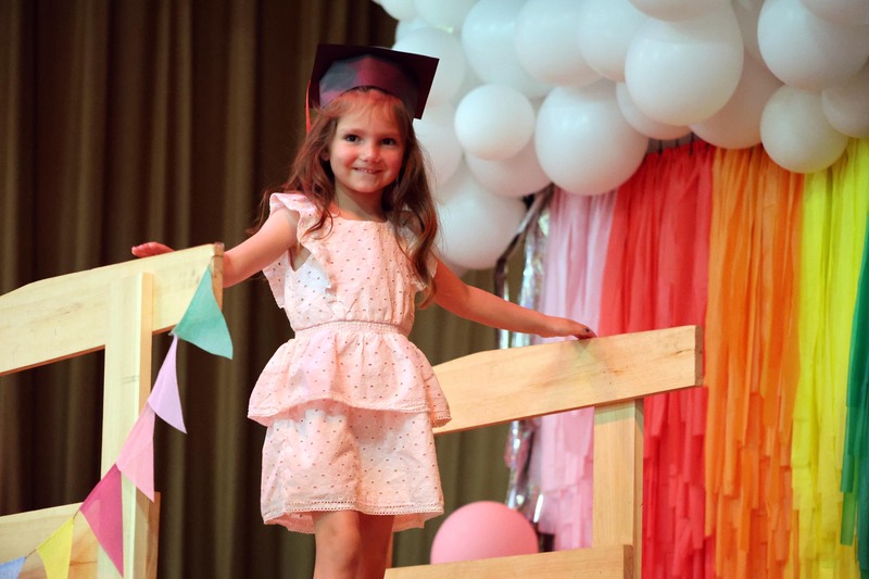 girl crossing over wooden bridge on stage