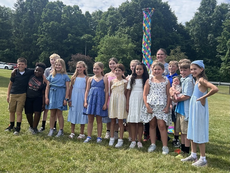 fourth graders pose with maypole
