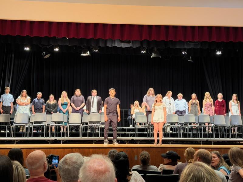 students are called onto stage during moving up ceremony