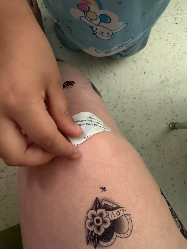 temporary tattoo being applied to arm