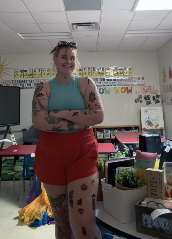 woman covered in temporary and real tattoos