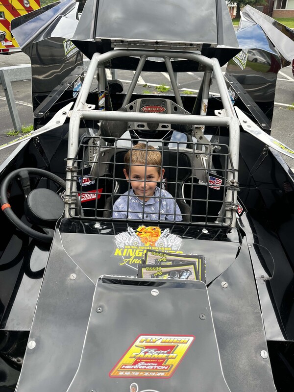 boy sitting in race car