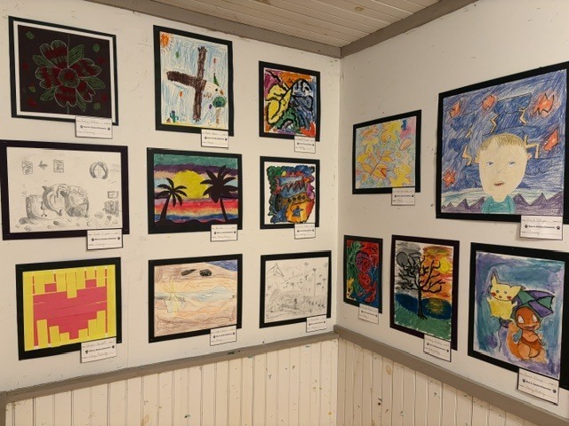 student artwork on display wall