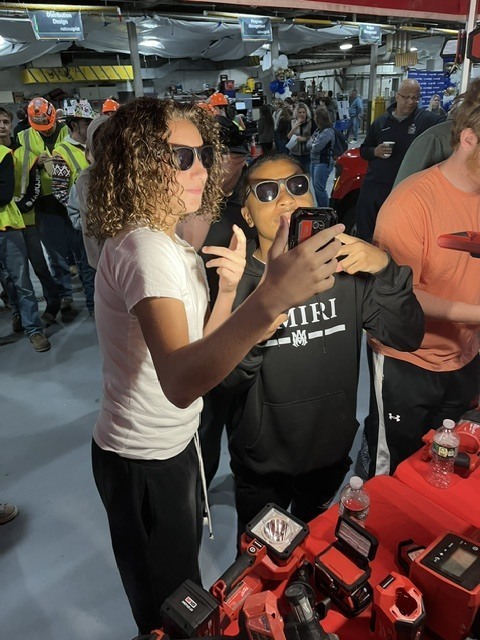 students looking at electric tools