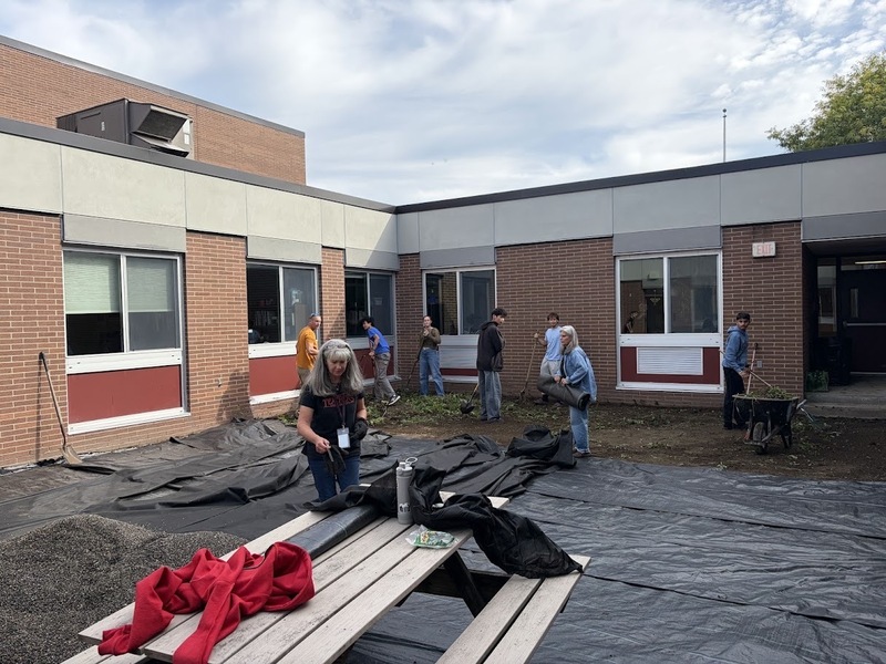 staff and students working in courtyard