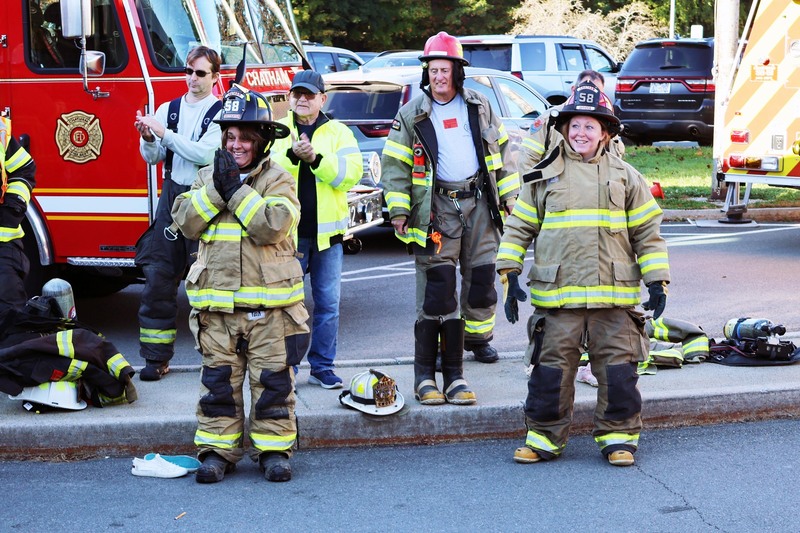 Ms. Van Alstyne and Ms. Ferris wearing firefighter gear