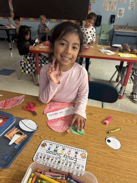 girl coloring paper apple