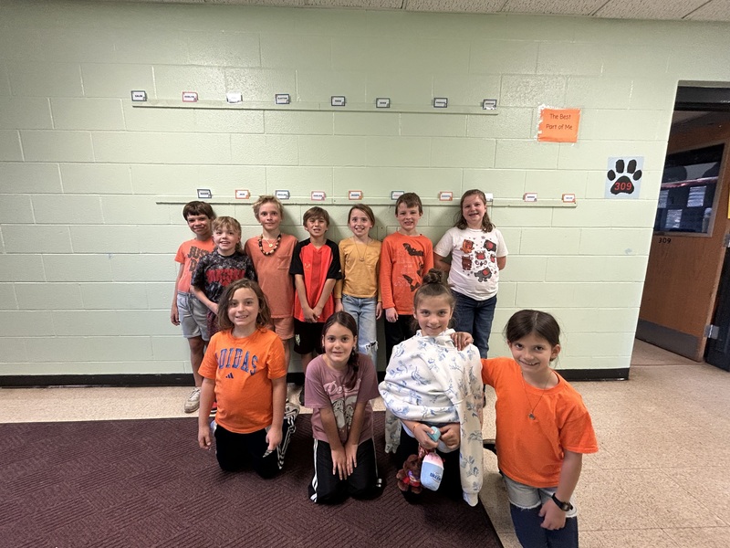 class photo of students wearing orange
