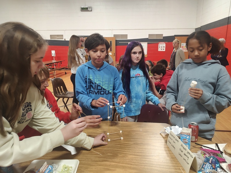 students building spaghetti towers