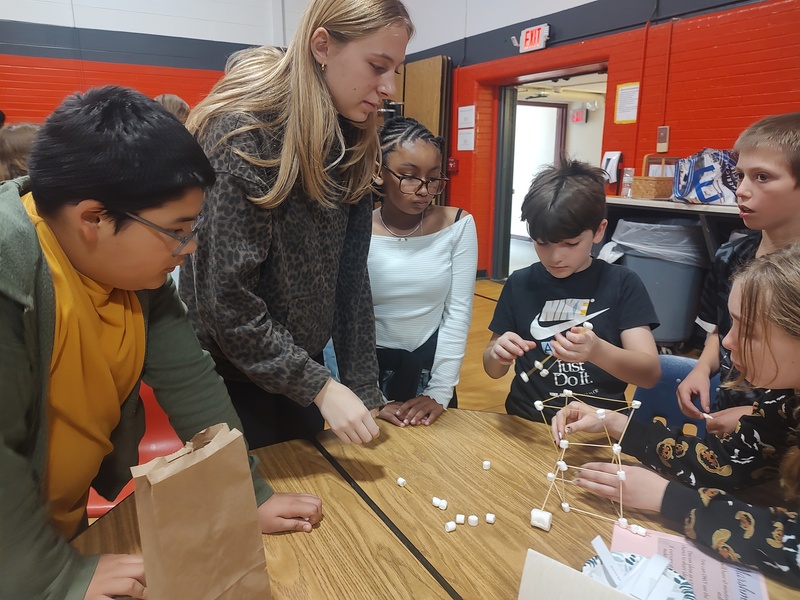 students building spaghetti towers