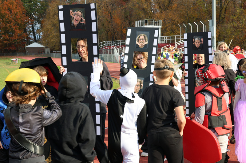 teacher in photo booth costumes