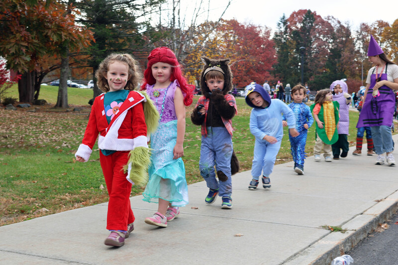 students in costumes march in Halloween parade