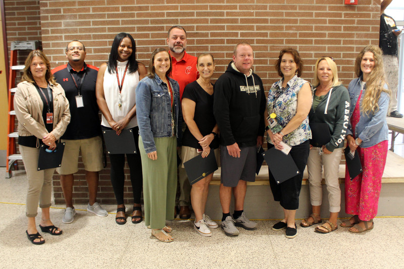 staff posing for photo in Chatham High School hallway
