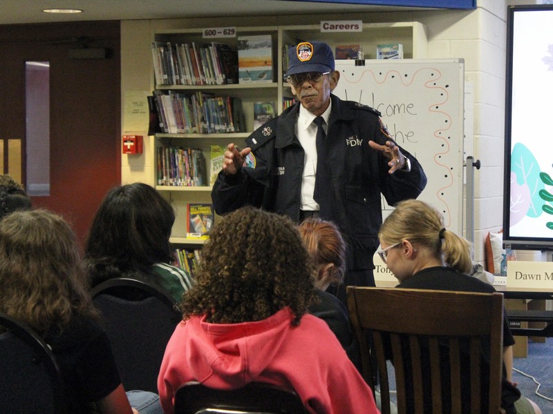 man in FDNY uniform talking to students