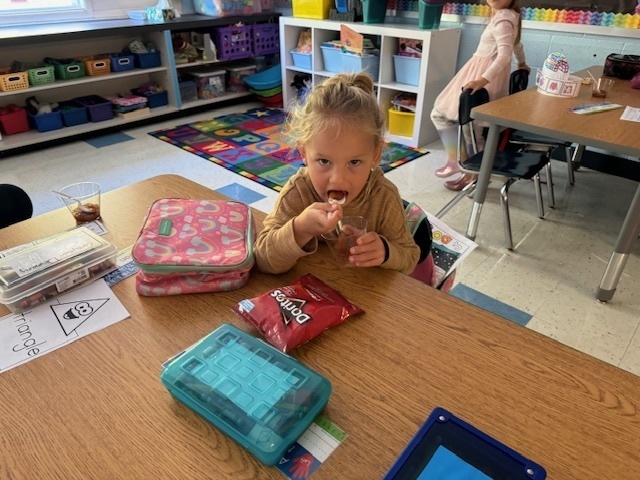 student tasting apple