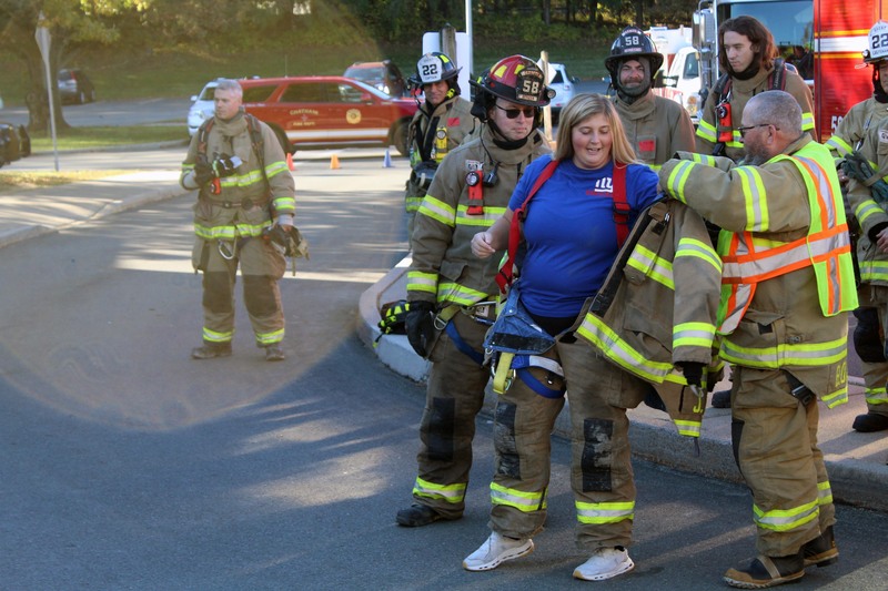 woman putting on bunker gear