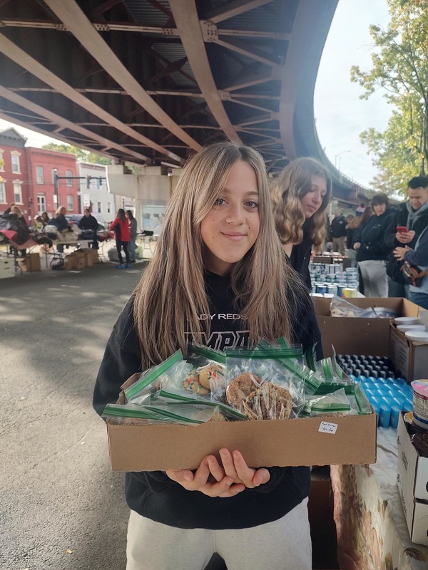 girl holding box of food