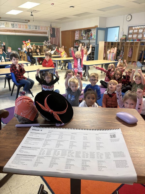 classroom waving to plush hedgehog toys