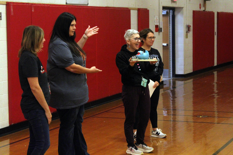 teachers holding up new trophy