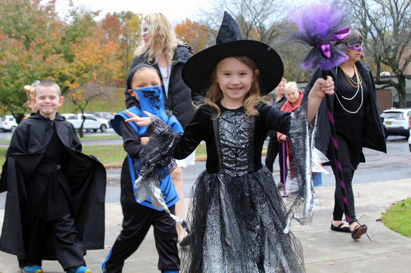 students in Halloween costumes walking on high school track