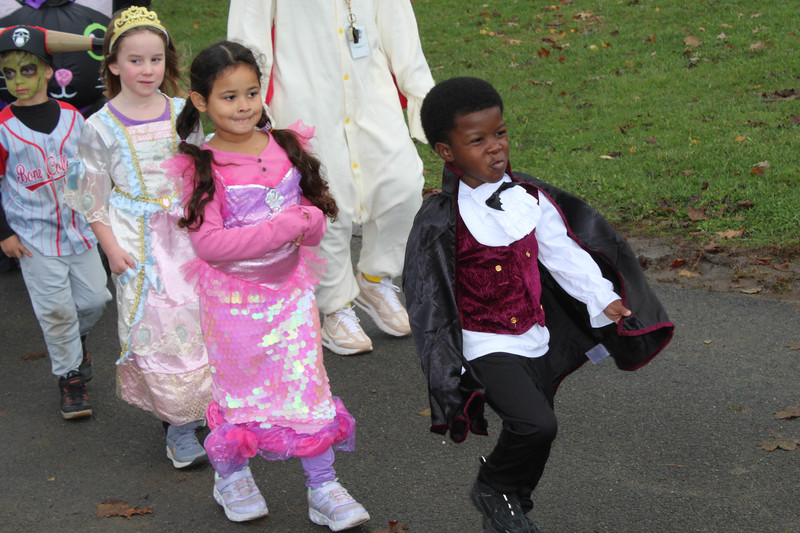 students in Halloween costumes walking on high school track