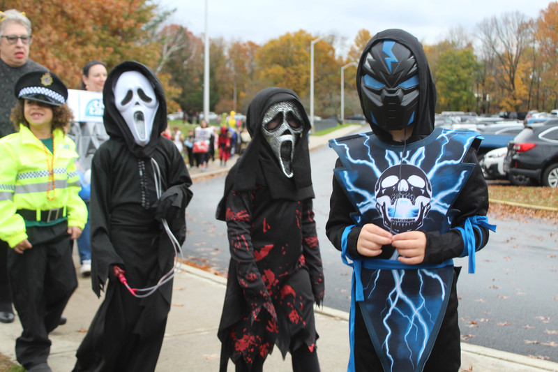 students in Halloween costumes walking on high school track