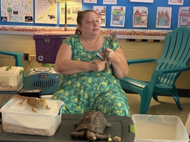 woman holding reptile