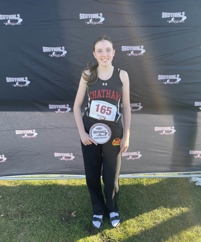 teenage girl holding section 2  class d trophy