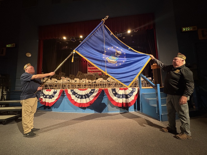 Two Men displaying navy flag