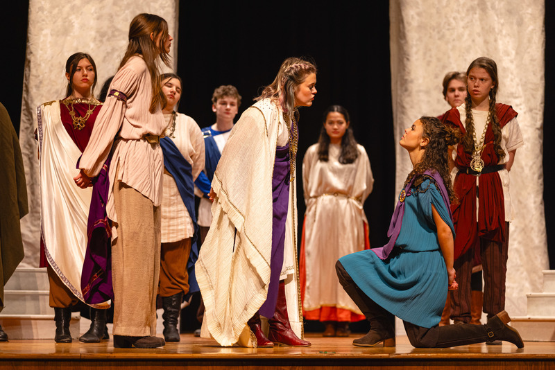 Students dressed in ancient Roman attire on stage in Julius Caesar