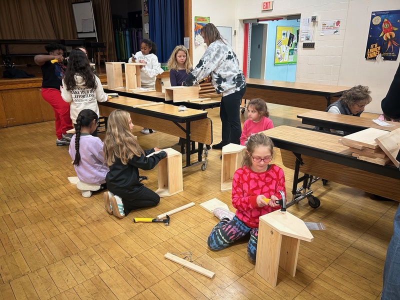 girls building toolboxes on floor and on tables