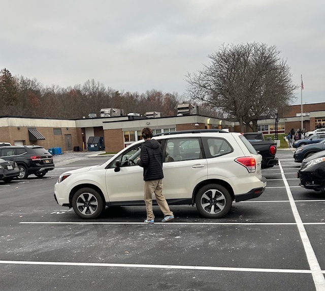 teenage boys checking driver  for seatbelt