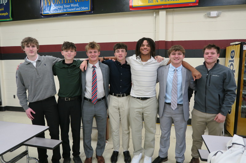 students wearing professional attire pose for group photo