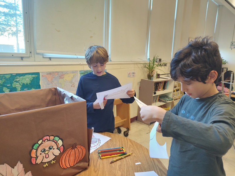 students decorating boxes with Thanksgiving theme