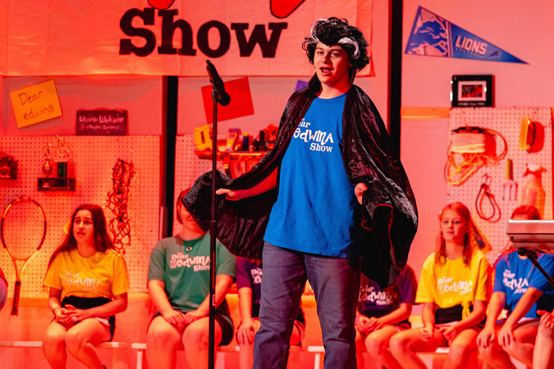 boy singing on stage