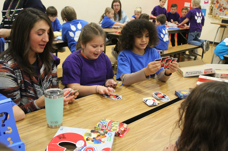 teacher and students playing card game