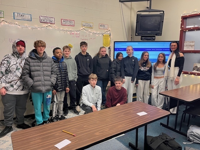 students and woman pose for group photo