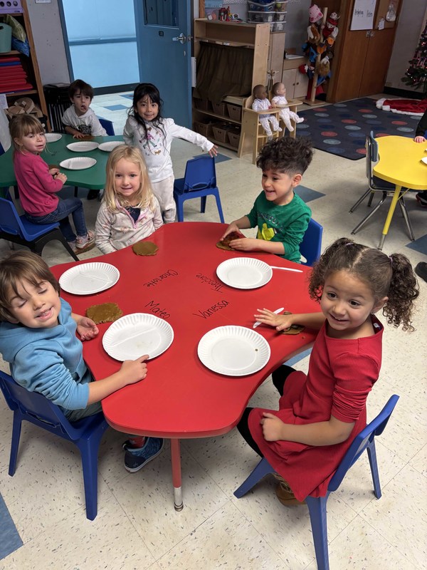 students eating gingerbread man cookies