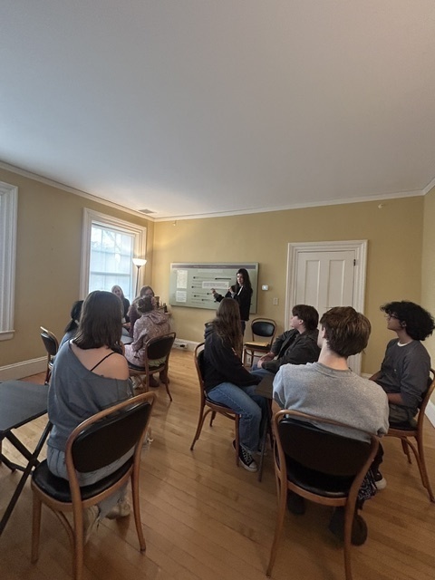 student watching woman give presentation