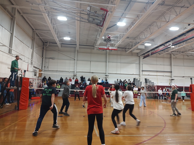 people playing volleyball in school gym