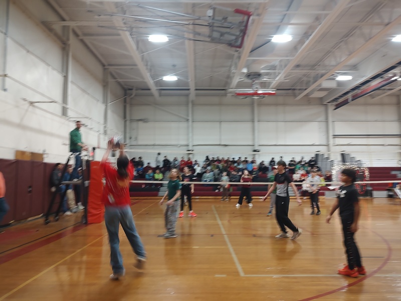 people playing volleyball in school gym