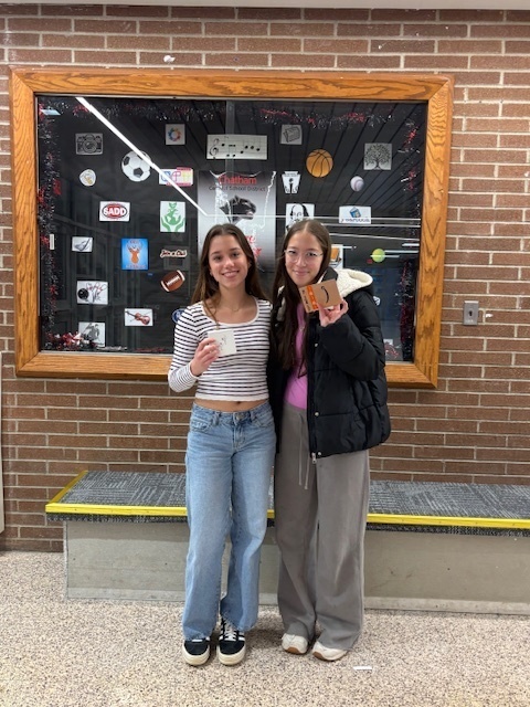two girls holding prizes