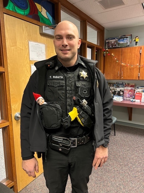 elf sticking out of deputy's pocket